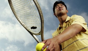 Man Serving Tennis Ball